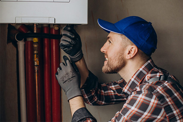 Licensed technician adjusting home heating system
